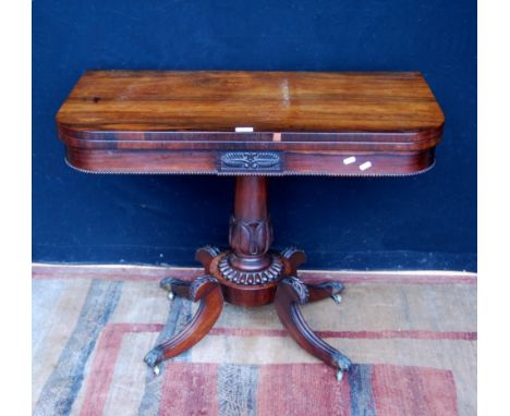 Regency rosewood card table, the fold-over top enclosing a later green baize interior, on a carved column, circular platform 