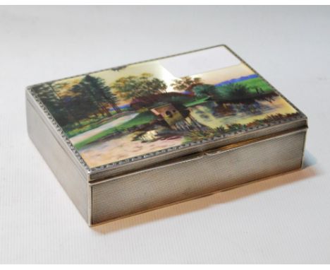 Silver cigarette box with enamel scene of a barn and a bridge, engine-turned, probably Austrian, c. 1900, 110mm x 82mm.CONDIT