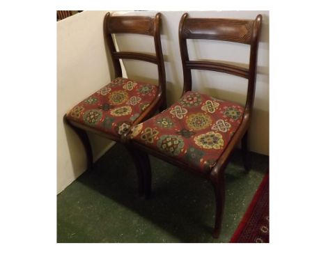 Pair of Regency mahogany curved bar back dining chairs with front sabre leg, tapestry drop in seats (2) 
