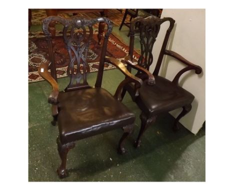 Pair of 20th century Chippendale carver chairs with inter-woven carved back and scrolled and carved arms, on claw and ball fe