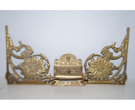 Pair of brass shelf brackets together with a brass toilet roll dispenser