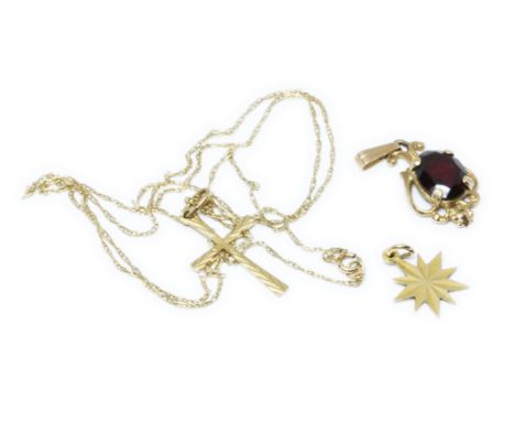 A hallmarked 9ct gold garnet pendant, together with a cross on chain and another pendant/charm, unmarked, gross weight 2.7g.