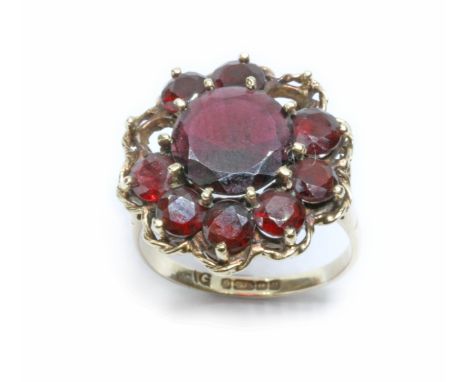 A 9ct gold garnet ring, the cluster measuring approximately 20mm, Birmingham 1994, gross weight 5.2g, size O.Condition - two 