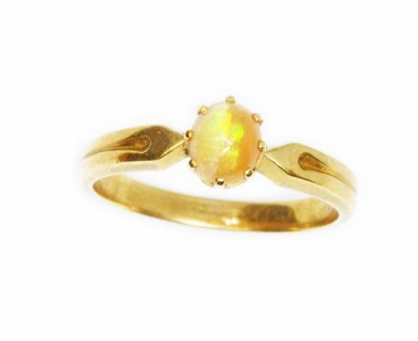 An opal cabochon ring, yellow band unmarked, gross weight 3.1g, size N.Condition - good, general wear only.