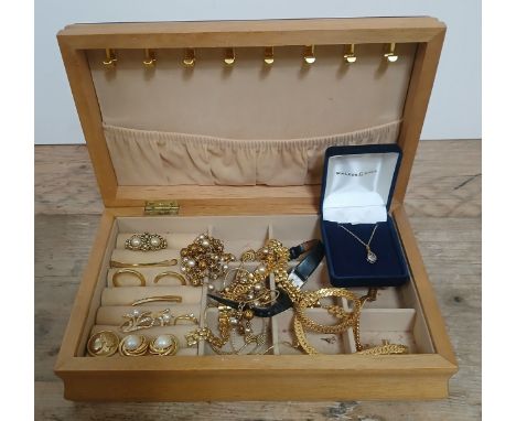A wooden jewellery and contents comprising mainly vintage gold plated jewellery and a 9ct gold pendant.