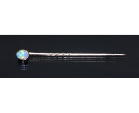 An opal stick pin, unmarked, length 53mm, gross weight 0.9g, with box.Condition - good play of colour, little wear.