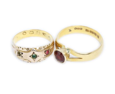 Two hallmarked 22ct gold rings, one set with a garnet, gross weight t4.8g, size F &amp; J.