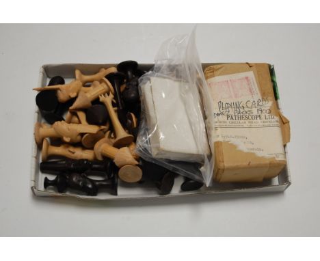 A pack of early 20th century playing cards together with various other playing cards, and carved tribal chess pieces
