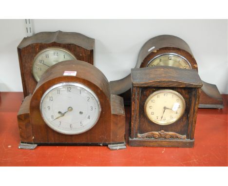 A 1950s Enfield oak cased mantel clock, having silvered dial with Arabic numerals, eight day movement; together with three ot