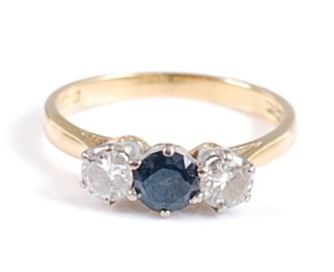 An 18ct yellow and white gold, sapphire and diamond three-stone ring, the centre round sapphire measuring approx 4.4 x 4.45mm