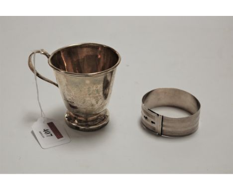 A George V silver christening mug, of plain tapering form; together with a silver bangle with engine turned decoration, gross