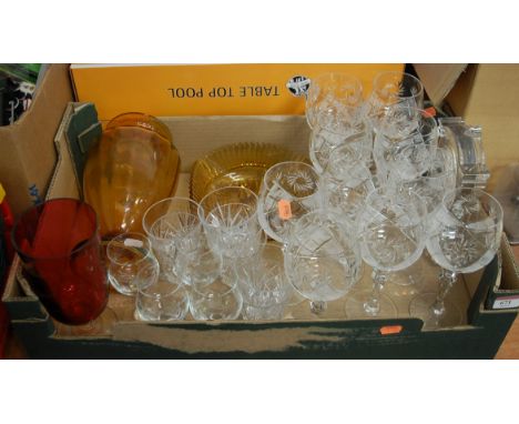 A collection of various cut and coloured glass ware to include drinking glasses, and a mantel clock