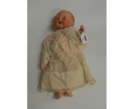 An Armand Marseille bisque head doll, having fixed blue eyes, open mouth, and bent limbed composition body, stamped to the na