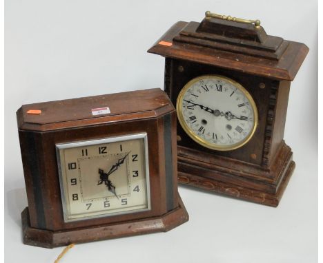 A late 19th century continental oak cased mantel clock, having a circular enamelled dial with Roman numerals and eight day mo