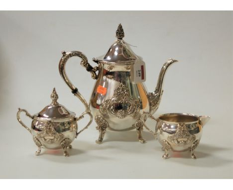 A modern silver plated three-piece tea set in the Georgian style, with C-scroll and floral relief decoration, comprising teap