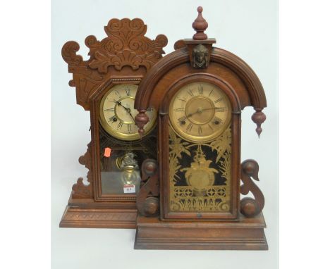 A late 19th century American walnut cased mantel clock having a painted dial with Roman numerals and eight day movement enclo