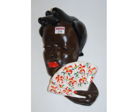 A West German pottery wall mask of a lady in the Goldscheider style, impressed 3682 verso, h.26cm; together with three Art De