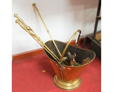 A set of three turned brass fire tools, comprising poker, shovel and tongs; together with a further shovel; a brass bracket; 