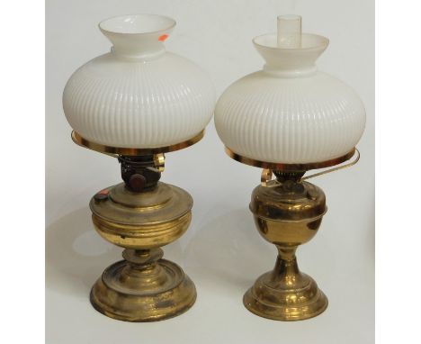 An early 20th century brass oil lamp, having opalescent glass shade and Duplex burner, h.50cm; together with one other simila