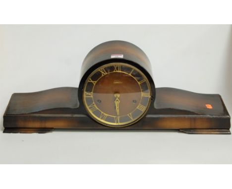 A 1950s beech cased mantel clock, the brass chapter ring with Roman numerals, having eight day movement striking on a gong, w