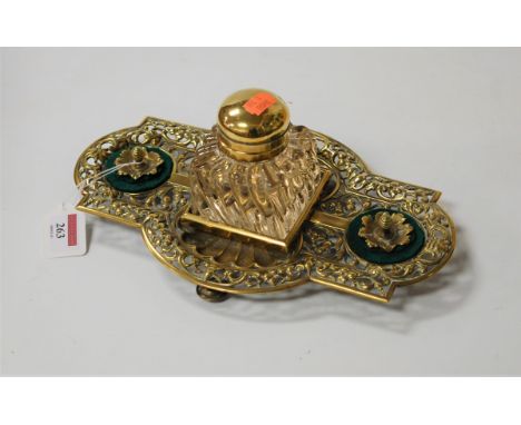 A Victorian style brass desk stand, of shaped rectangular form, having pierced floral decoration and central glass inkwell, w