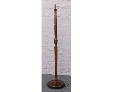 A mahogany turned and reeded standard lamp.