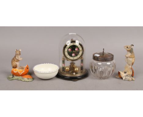 A mixed group to include Koma torsion clock under glass dome, silver top storage jar, Border Fine Arts and Poole.