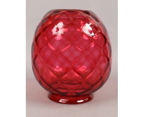 A large quilted cranberry glass oil lamp shade.