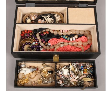 A case of costume jewellery to include rings, brooches, necklaces, beads etc.