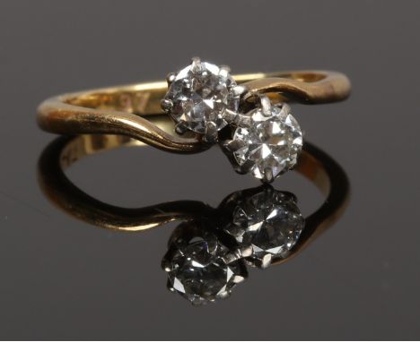 A mid 20th century 18ct gold and platinum two stone diamond crossover ring, approximately 0.45ct, total size L.