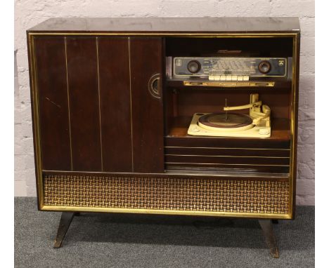 A vintage Grundig Balmoral 7070 3D radiogram with Collaro turntable and built in vinyl record rack.