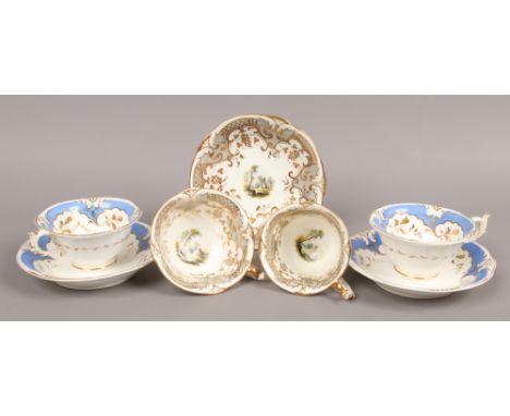 A Rockingham coffee cup tea cup and saucer enamelled with romantic landscapes under gilt and grey grounds along with two Rock