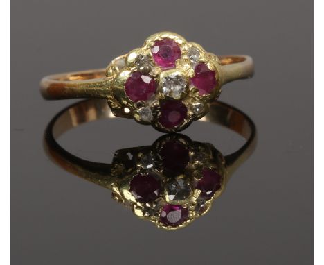 A Victorian yellow metal ruby and diamond five stone cluster ring, size M.
