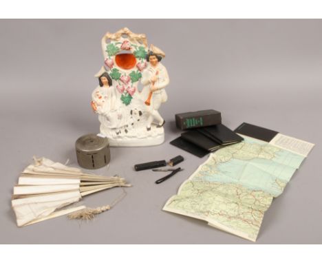 A 19th century Staffordshire pocket watch holder formed as a courting couple with spaniel and sheep, along with a boxed minia