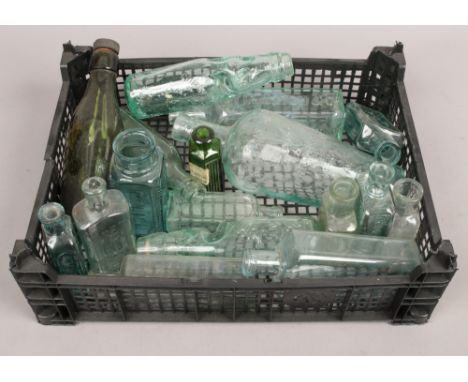 A collection of vintage glass storage bottles including advertising examples.
