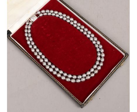 A cased double row grey pearl necklace.