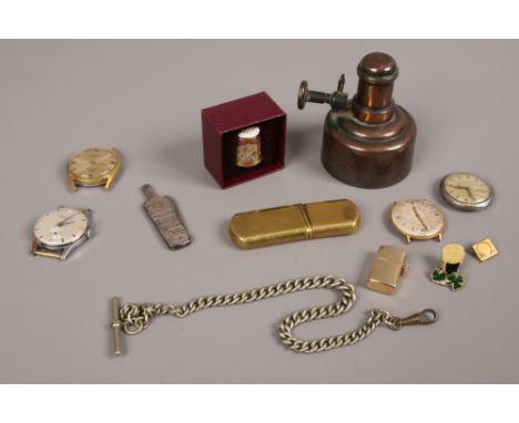 A small box of collectables including vintage brass lighter, Omega lapel badge pin, manual watch heads and a Seagers special 