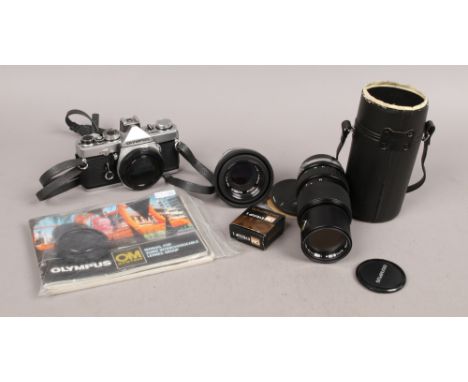 An Olympus OM-1 SLR 35mm camera along with OM-System Auto-S 1:1,8 f=50mm macro lens, a cased OM-System Auto-200m 1:4 f=75 - 1
