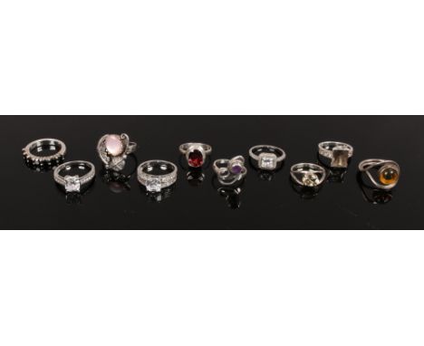 A Thomas Sabo silver dress ring set with seven dark paste stones and nine other silver dress rings.