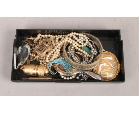 A collection of costume jewellery to include cameo simulated pearls, brooches and bangles etc.