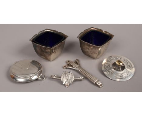 A group of silver items to include Scottish brooch, pair of salt cellars, compact etc.