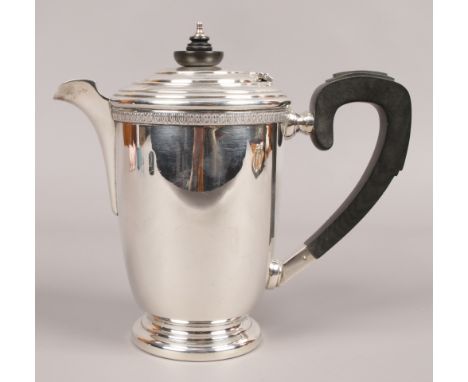 A George VI silver hot water jug by G. Bryan &amp; CO. with turned hardwood finial and carved handle, assayed Birmingham 1941