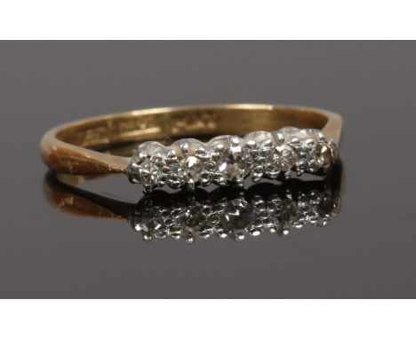 An 18ct gold and platinum mounted five stone diamond ring, mid 20th century, size M1/2.