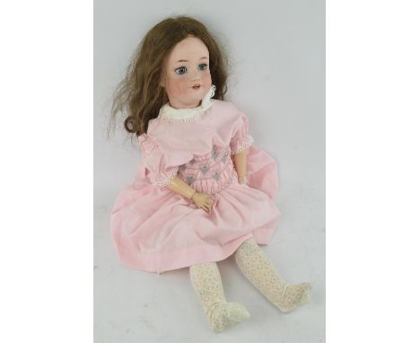An early 20th century Simon and Halbig 'Jutta' bisque head German doll.  Incised 1348 and 11 1/2, with dark wig and jointed c