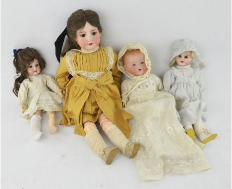 An Armand Marseille bisque head doll, No 390 (52cm), two further, smaller Armand Marseille bisque head dolls and a bisque hea