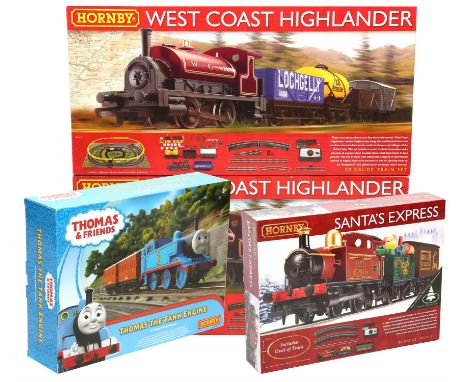 Four Hornby OO gauge train sets ; West Coast Highlander (x2) (R1157), Santa's Express (R1210) and Thomas The Tank Engine, all