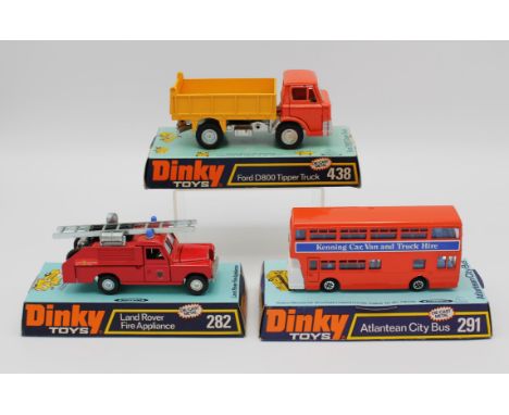 Three Dinky die-cast vehicles comprising ; 282 Land Rover Fire Appliance, 438 Ford D800 Tipper Truck and 291 Atlantean City B
