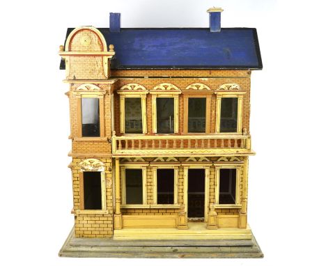 A late 19th century German softwood model of a two-storey doll's house by Moritz Gottschalk, the exterior covered in lithogra