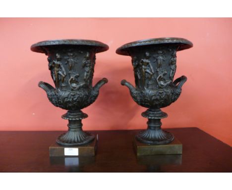 A pair of Italian style cast bronze campana shaped two handled urns, 31cms h 