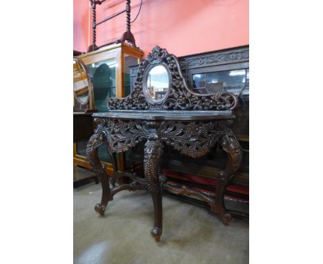 An eastern carved hardwood console table, 130cms h x 131cms w 